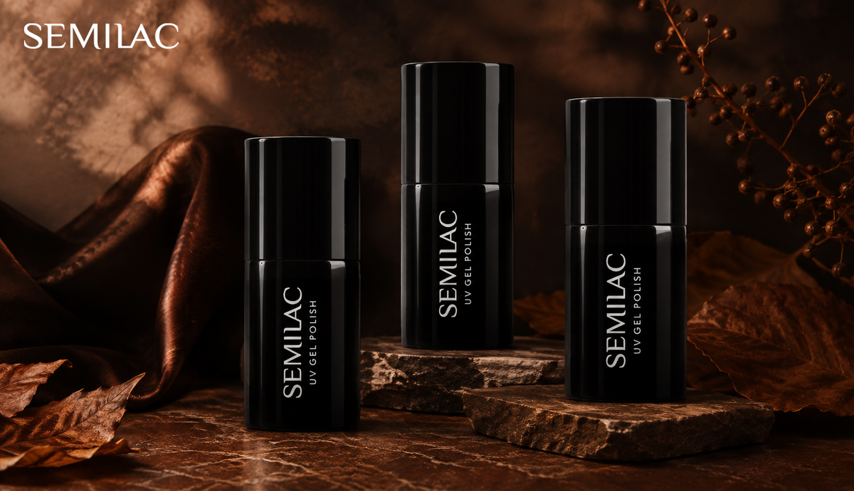 Three black Semilac gel polish bottles arranged on stone against autumn leaves and copper fabric