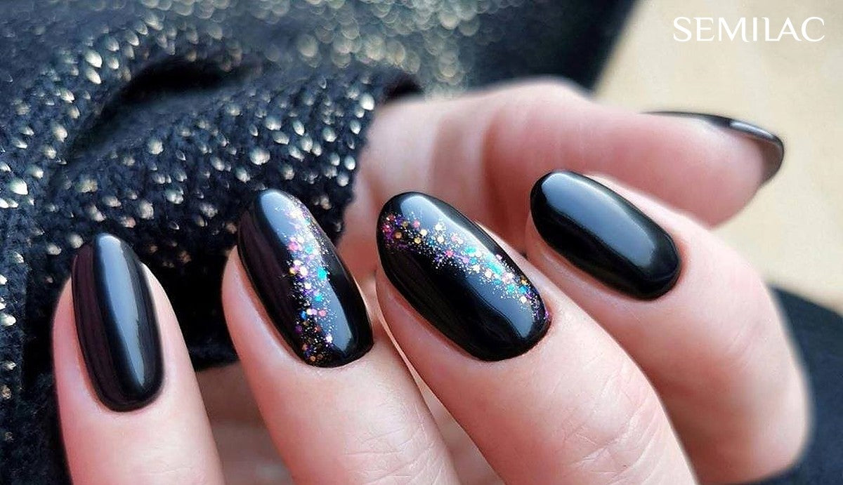 Glossy black gel nails with a multicoloured glitter streak like fireworks